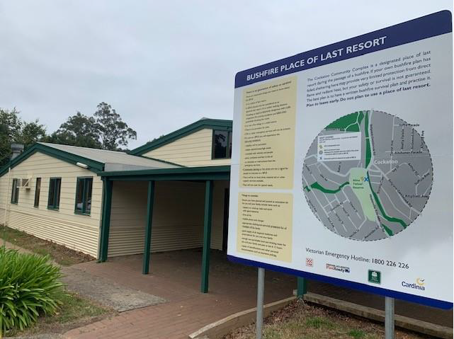 Picture of Cockatoo Community Complex - cream and green building with information sign titled Bushfire Place of Last Resort