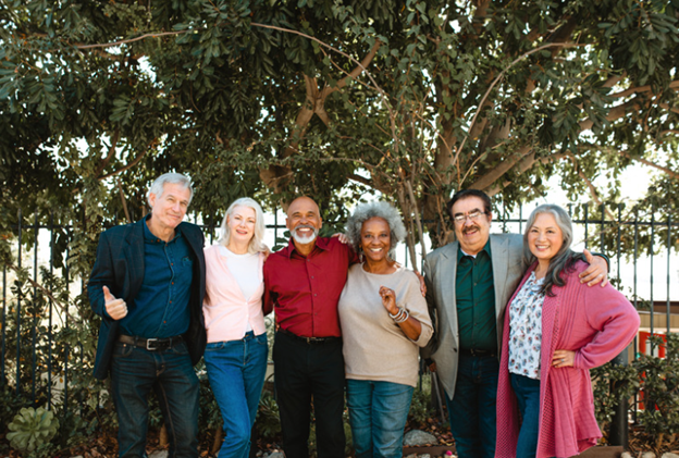 Mixture of six adults standing together smiling